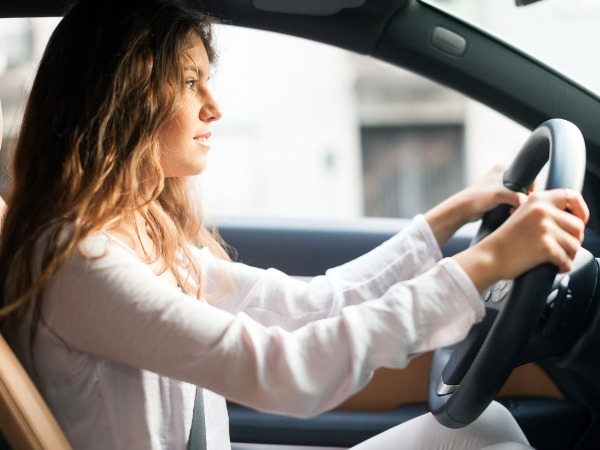 Woman Driving a White Car