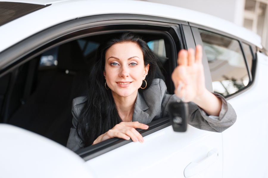 Woman Driving a White Car