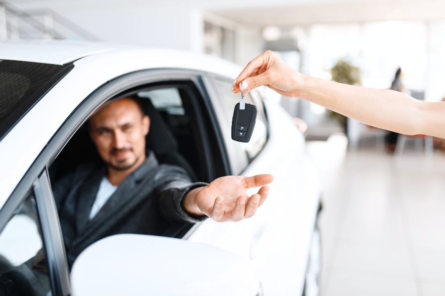 Man Driving a White Car