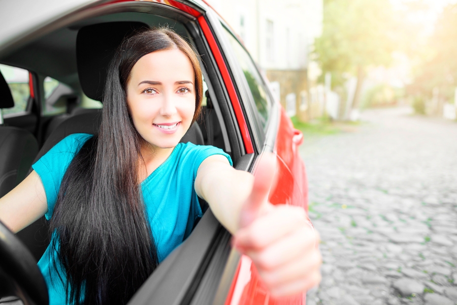 Woman Driving a Red Car