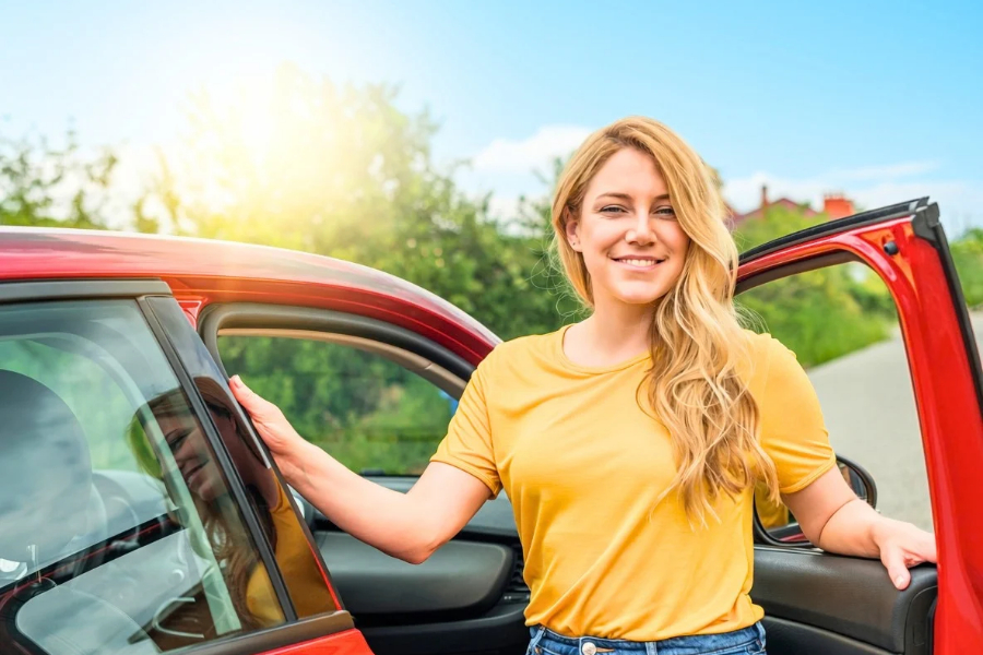 Woman Driving a Red Car