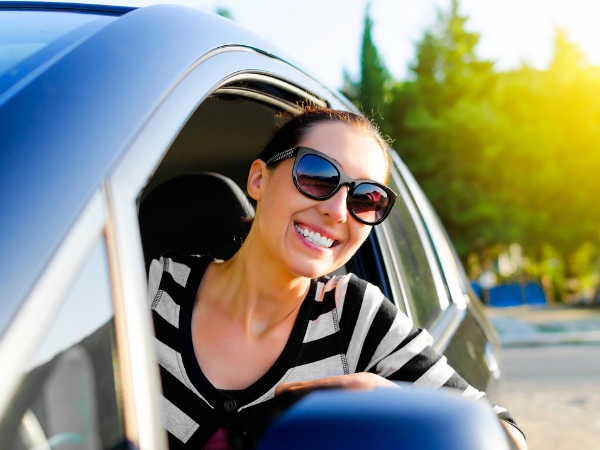 Woman Driving a Blue Car
