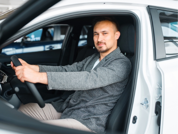 Man Driving a White Car
