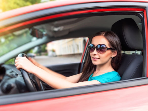 Woman Driving a Red Car