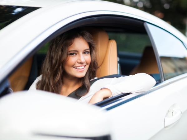 Woman Driving a White Car