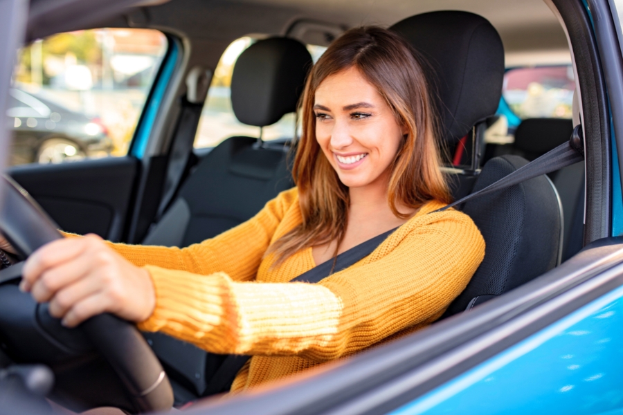Woman Driving a Blue Car