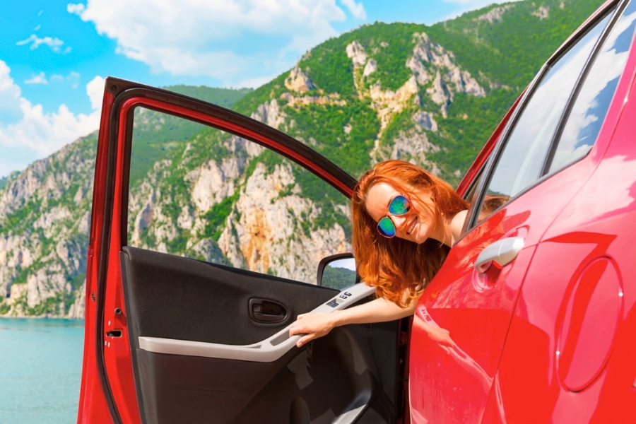 Woman Driving a Red Car