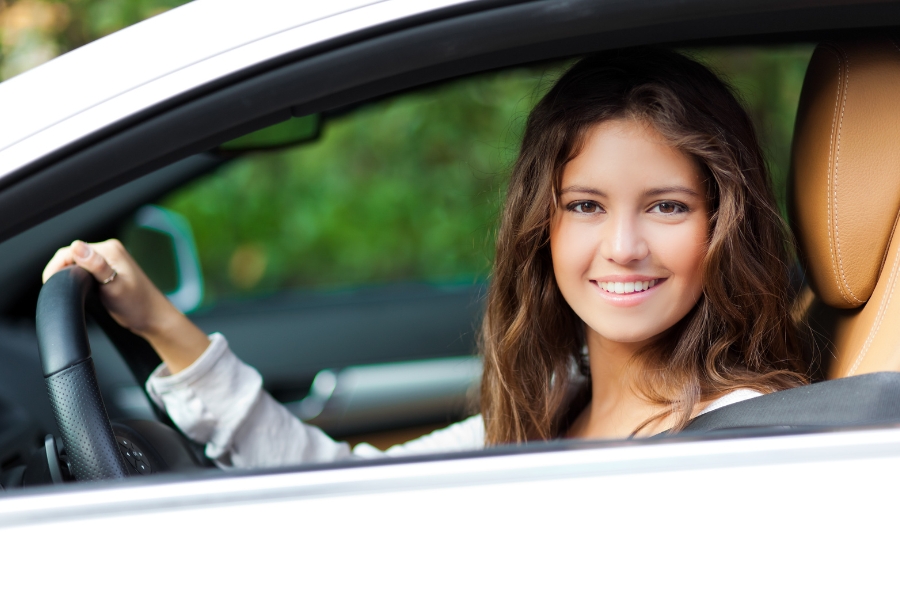 Woman Driving a White Car